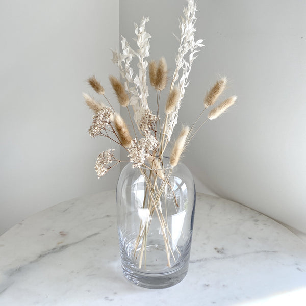 Artifact Home www.artifacthome.ca Mouth blown and handblown round clear glass vase home decor with bunny tails, baby's breath and ruscus leaves 